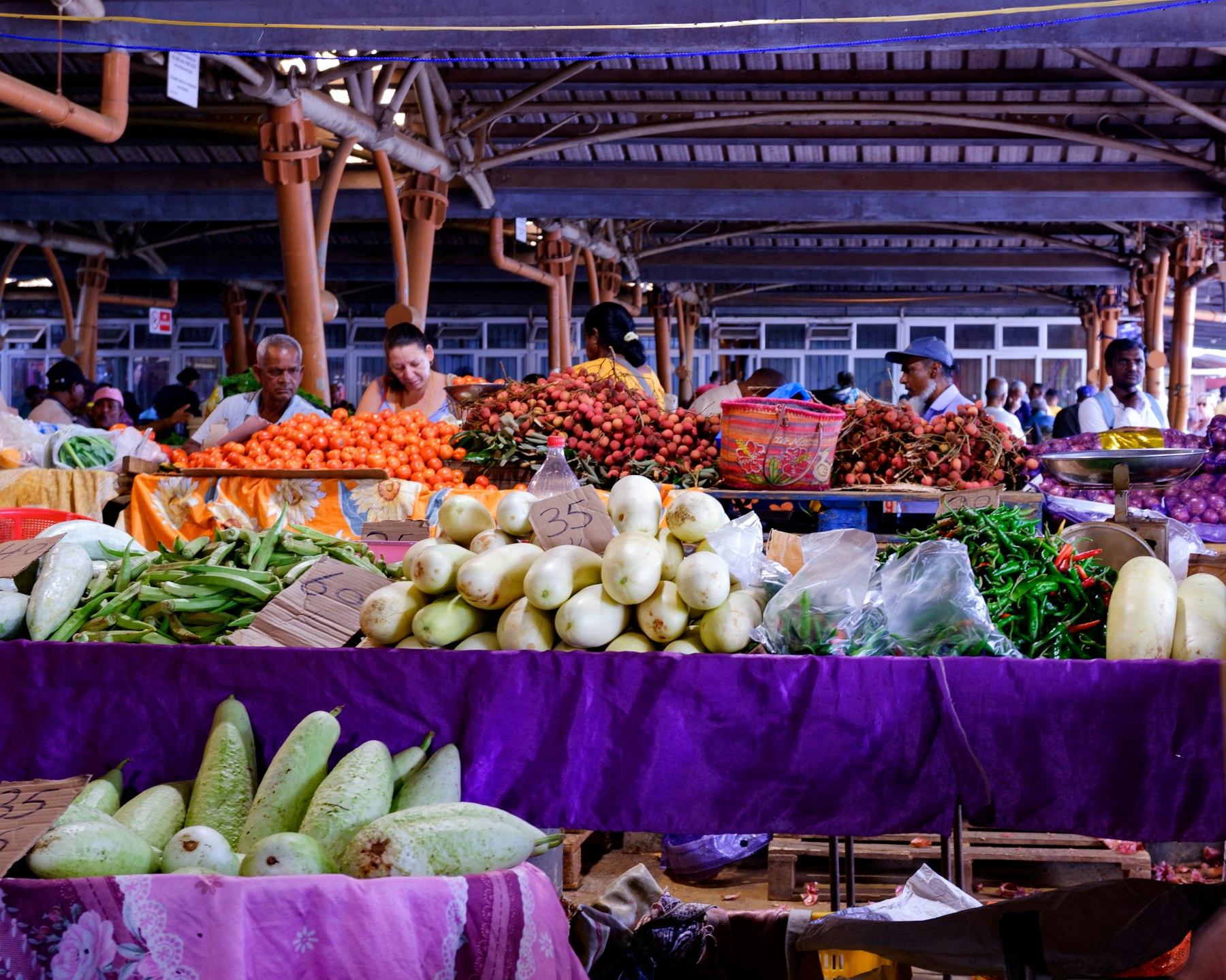 Produce stalls inside a covered Mauritian market